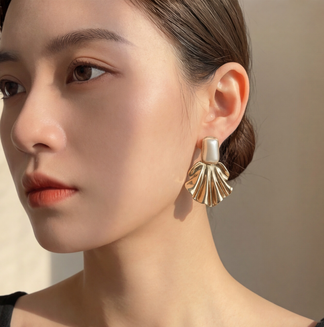 Brinco Dourado com detalhe perolado e design de concha